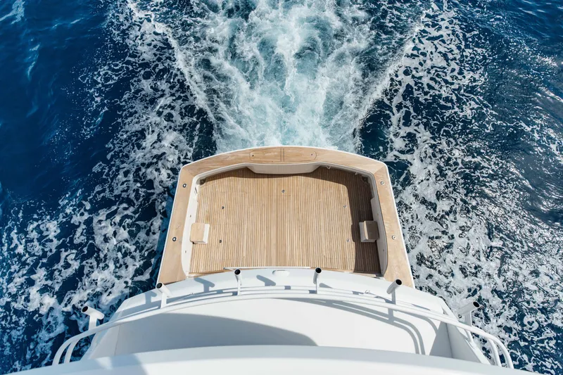 Slide: The Image of Aerial view of 2012 Viking 76 Enclosed Bridge yacht cruising on blue ocean. - 23