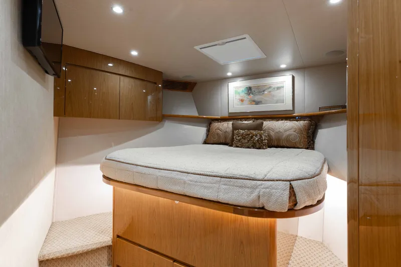 Slide: The Image of Luxurious cabin interior of 2012 Viking 76 Enclosed Bridge yacht with cozy bed and elegant decor. - 92