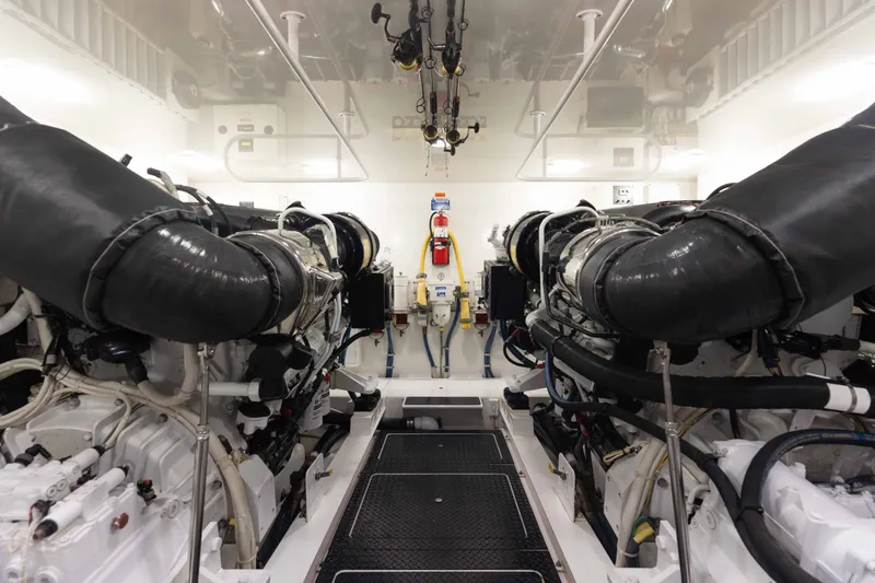 Slide: The Image of Engine room of 2012 Viking 76 Enclosed Bridge yacht, featuring dual engines and clean layout. - 104