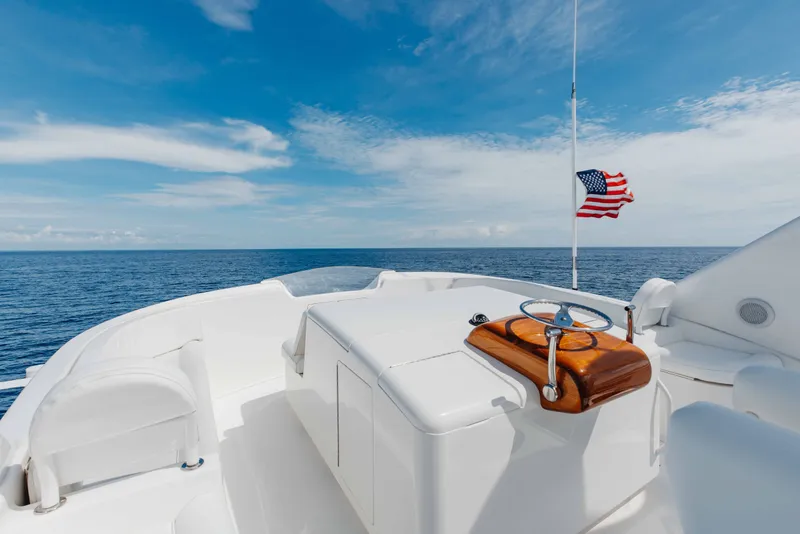 Slide: The Image of 2012 Viking 76 Enclosed Bridge yacht deck with ocean view and American flag. - 45