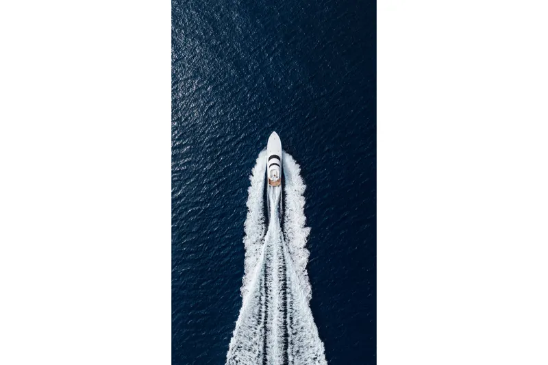Slide: The Image of Aerial view of 2012 Viking 76 Enclosed Bridge yacht cruising on open water. - 14