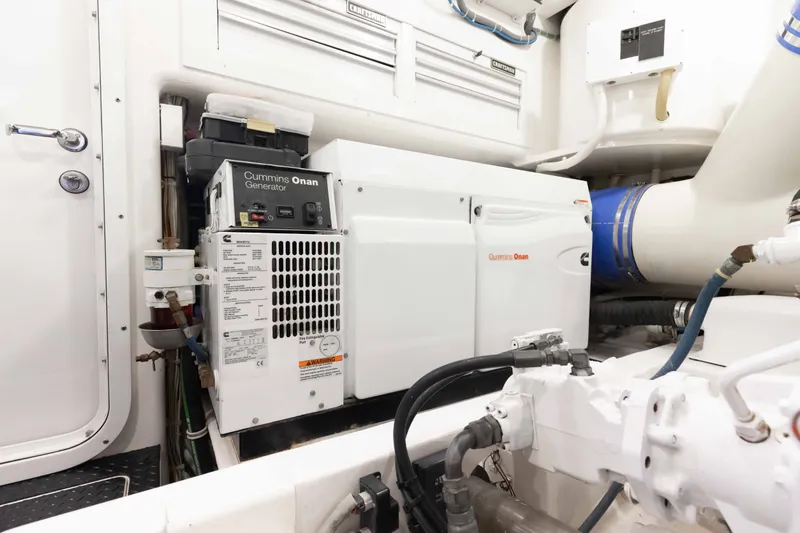 Slide: The Image of Engine room of 2012 Viking 76 Enclosed Bridge with Cummins Onan generator. - 116