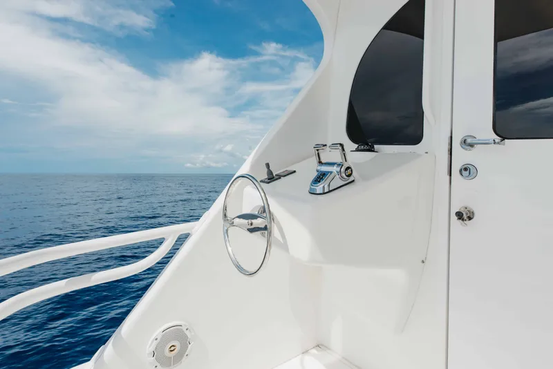 Slide: The Image of Steering area of 2012 Viking 76 Enclosed Bridge yacht with ocean view. - 36