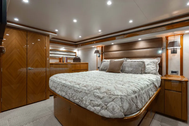 Slide: The Image of Luxurious bedroom interior of 2012 Viking 76 Enclosed Bridge yacht with elegant wood finishes. - 85