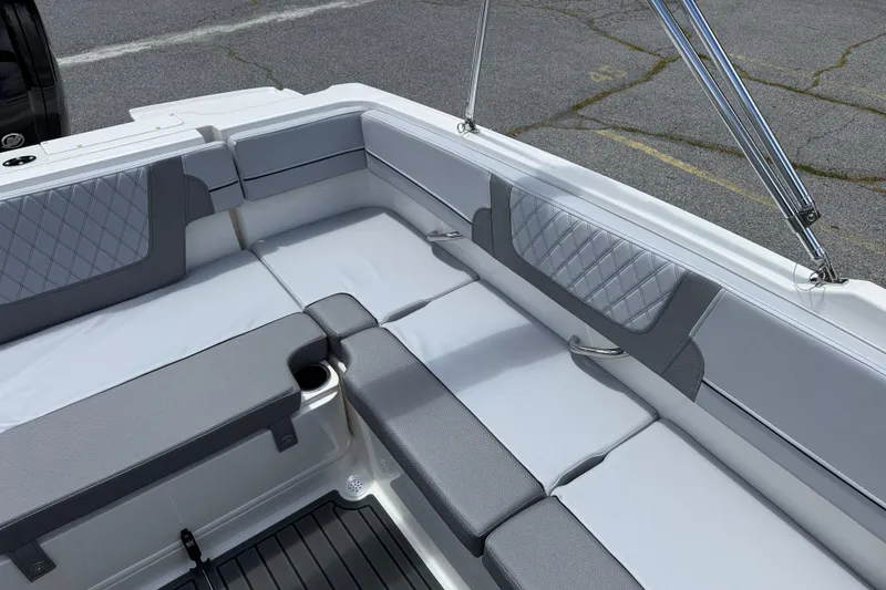 Slide: The Image of 2026 Bayliner VR4 Bowrider OB interior with gray cushioned seating and sleek design. - 4