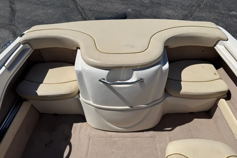 Slide: The Image of Interior seating of a 2000 Sea Ray 180 Bow Rider boat, featuring beige cushions. - 14