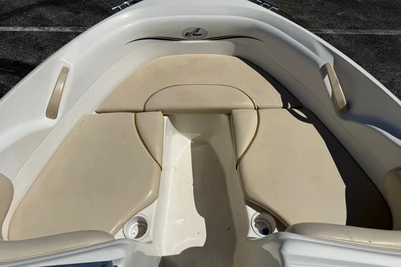 Slide: The Image of 2000 Sea Ray 180 Bow Rider boat interior with beige seating and sleek design. - 11