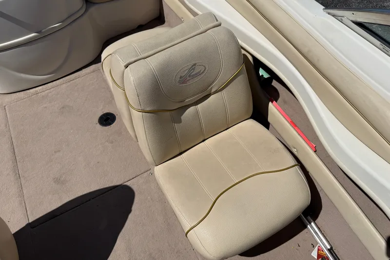 Slide: The Image of Beige seat on 2000 Sea Ray 180 Bow Rider boat, featuring clean upholstery and carpeted flooring. - 12