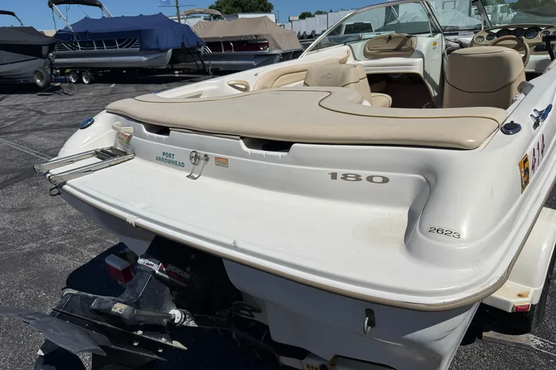 Slide: The Image of 2000 Sea Ray 180 Bow Rider boat, rear view, parked at marina with other boats. - 6