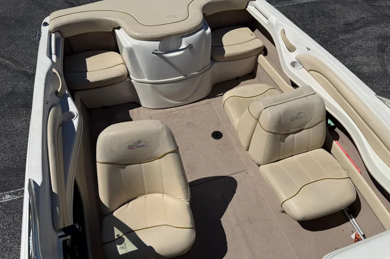 Slide: The Image of 2000 Sea Ray 180 Bow Rider interior with beige seating and carpeted floor. - 16