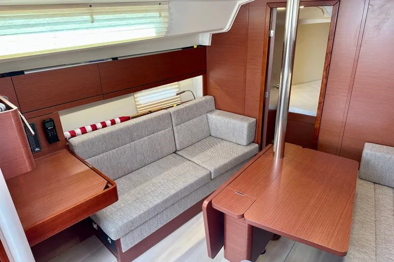 Slide: The Image of Interior of 2021 Hanse 348 yacht with modern wood finish and cozy seating area. - 23