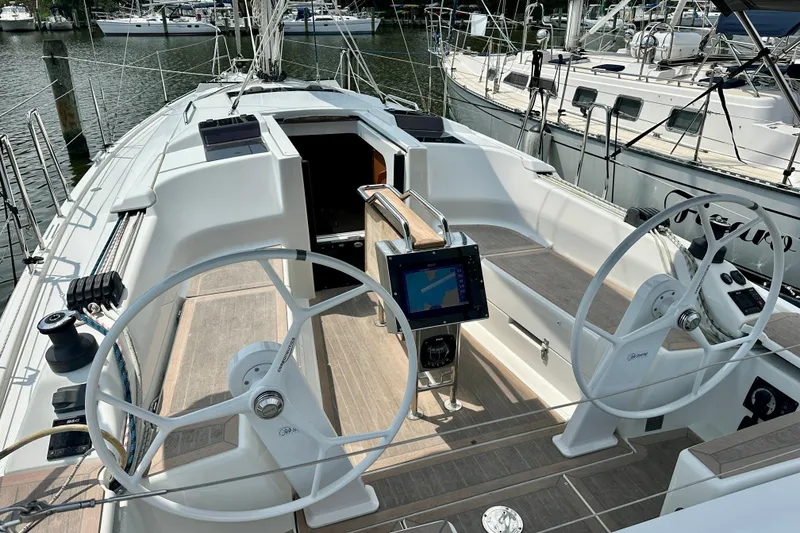 Slide: The Image of Modern 2021 Hanse 348 sailboat cockpit with dual steering wheels and navigation system. - 10