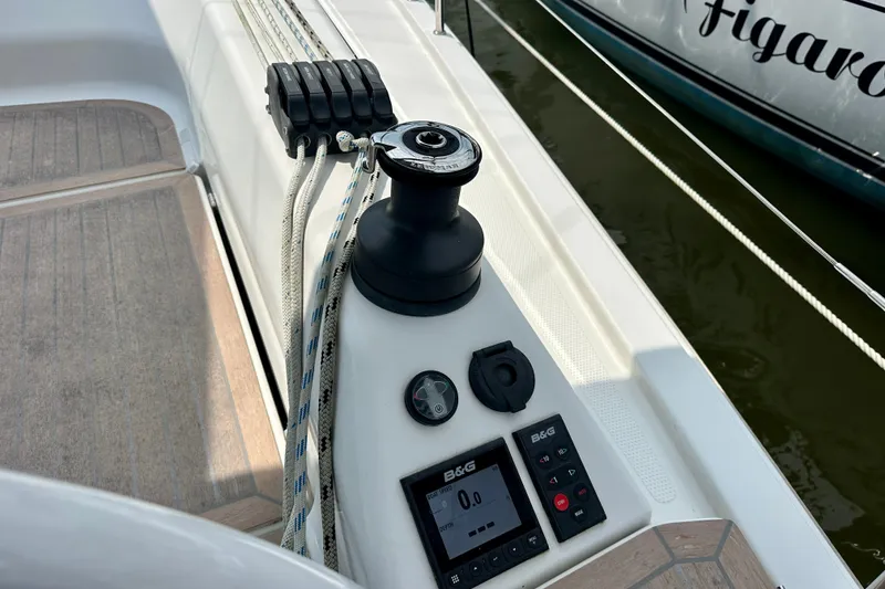 Slide: The Image of Cockpit controls of a 2021 Hanse 348 sailboat, featuring winch and navigation instruments. - 13