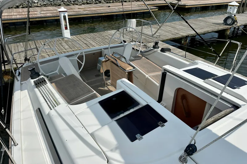 Slide: The Image of 2021 Hanse 348 sailboat cockpit with dual steering wheels at marina dock. - 17
