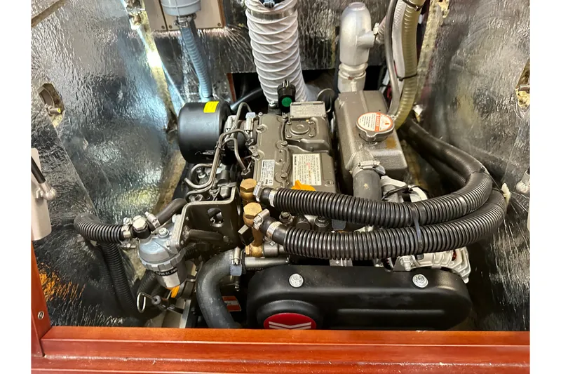 Slide: The Image of Engine compartment of a 2021 Hanse 348 sailboat, showcasing detailed mechanical components. - 28