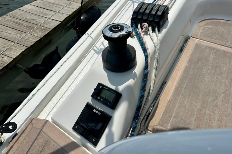 Slide: The Image of Hanse 348 sailboat deck with winch, ropes, and B&G navigation controls, 2021 model. - 14