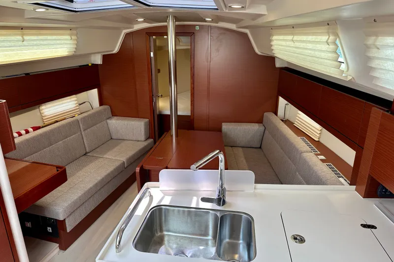 Slide: The Image of Interior of 2021 Hanse 348 yacht with modern kitchen and cozy seating area. - 21