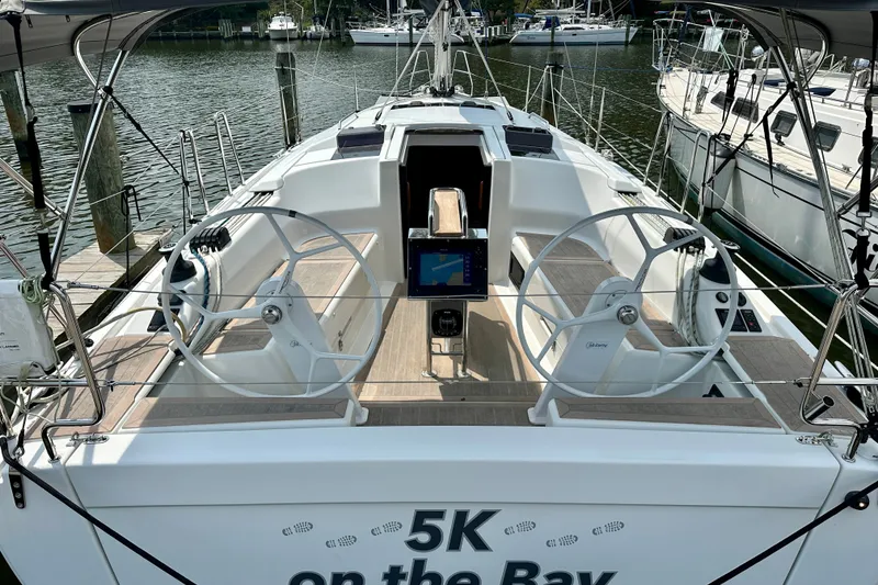 Slide: The Image of 2021 Hanse 348 sailboat cockpit with dual steering wheels docked at marina. - 6