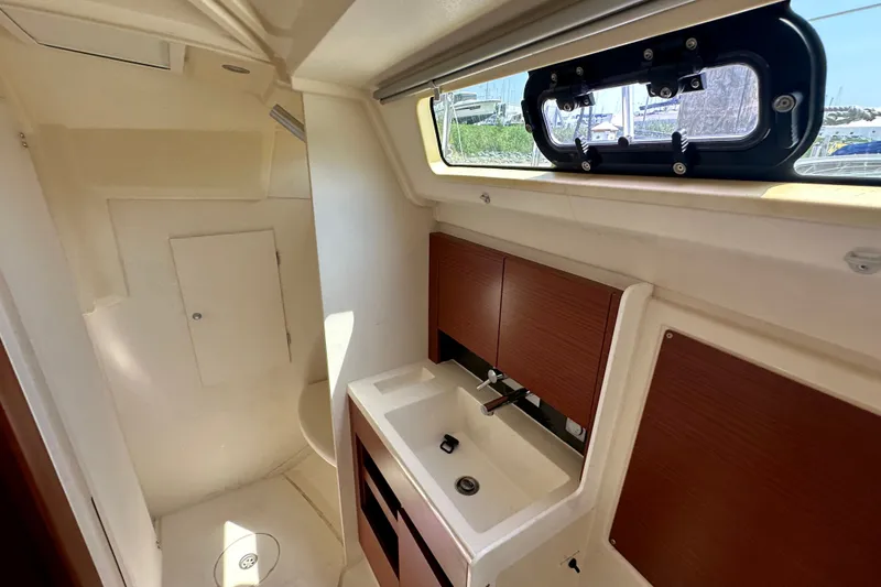 Slide: The Image of Interior of 2021 Hanse 348 yacht bathroom with sink, window, and storage cabinets. - 24
