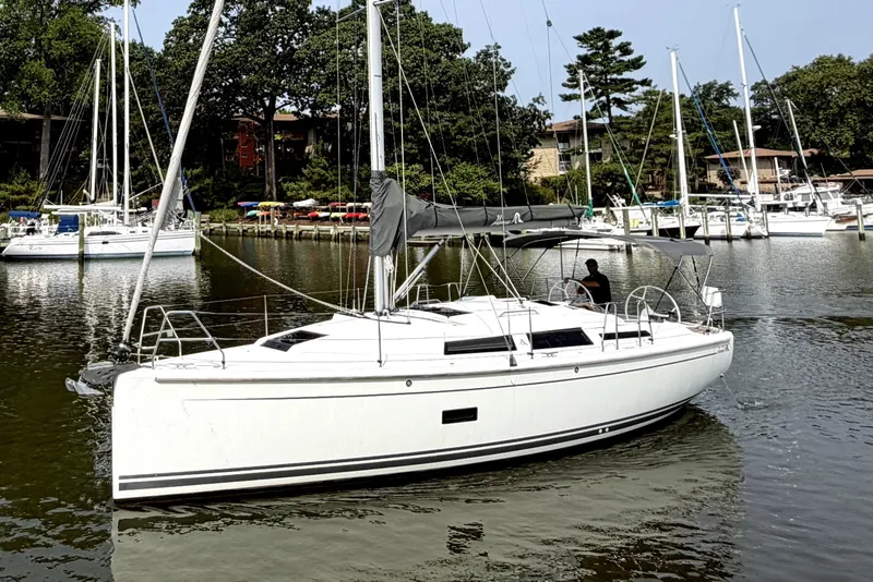 The Image of 2021 Hanse 348 sailboat docked in a serene marina setting. - 0