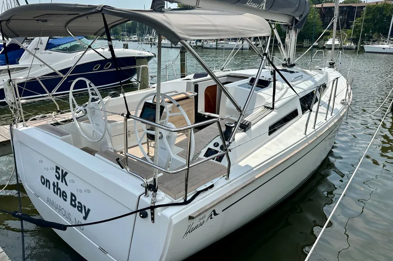 Slide: The Image of 2021 Hanse 348 sailboat docked in marina, featuring sleek design and spacious cockpit. - 7