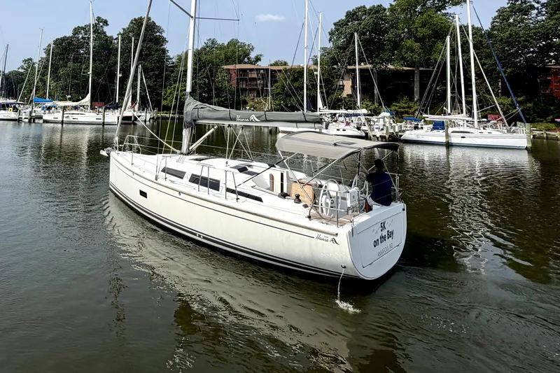 Slide: The Image of Sailing yacht Hanse 348, 2021 model, cruising in a marina with other boats. - 3