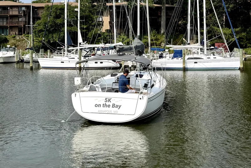 Slide: The Image of 2021 Hanse 348 sailboat named "5K on the Bay" in Annapolis marina. - 4