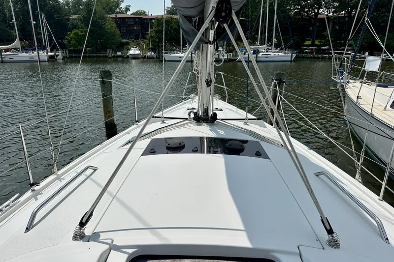 Slide: The Image of 2021 Hanse 348 sailboat docked in a serene marina setting. - 15