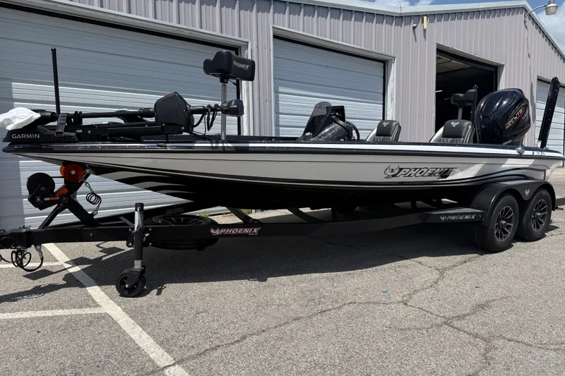Slide: The Image of 2027 Phoenix 721 ZXL fishing boat parked outside a garage, featuring Garmin equipment. - 6