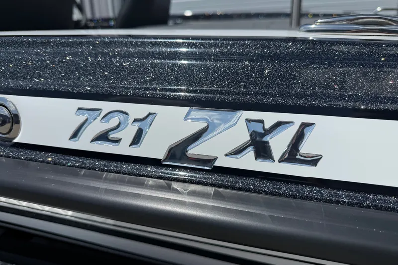 Slide: The Image of Close-up of 2027 Phoenix 721 ZXL model emblem on a glittery surface. - 3