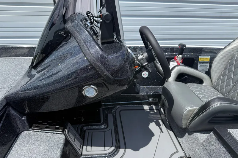 Slide: The Image of 2027 Phoenix 721 ZXL boat cockpit with steering wheel and cushioned seat. - 11