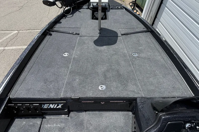 Slide: The Image of 2027 Phoenix 721 ZXL boat deck with gray carpeting and storage compartments. - 14