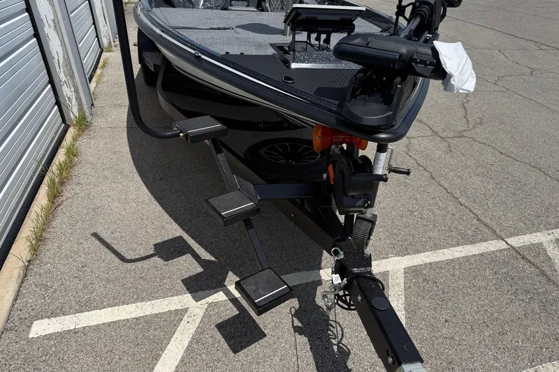 Slide: The Image of 2027 Phoenix 721 ZXL boat on trailer, parked on pavement near storage units. - 7