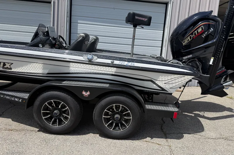 Slide: The Image of 2027 Phoenix 721 ZXL boat on trailer, featuring sleek design and Yamaha engine. - 19