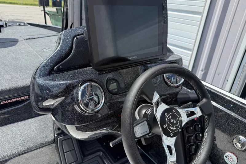 Slide: The Image of Dashboard of a 2027 Phoenix 721 ZXL boat with Garmin display and steering wheel. - 16