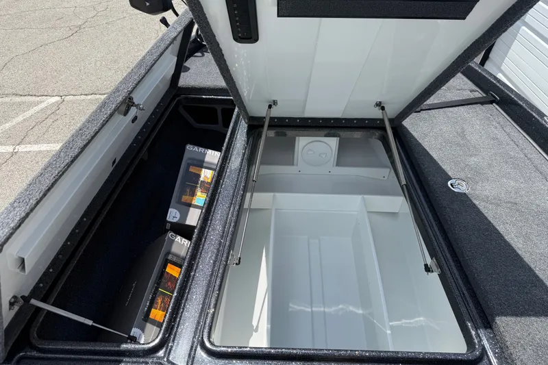 Slide: The Image of Open storage compartments of a 2027 Phoenix 721 ZXL boat, featuring Garmin electronics. - 15