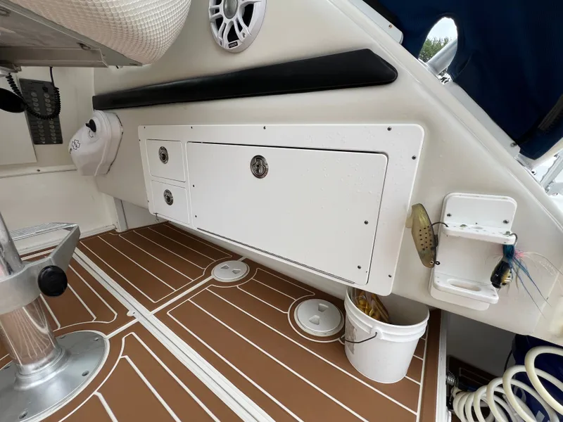 Slide: The Image of The image shows the cockpit of a 2004 Wellcraft 330 Coastal with storage and a speaker. - 21