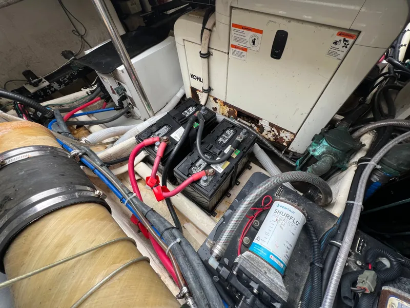 Slide: The Image of View of a 2004 Wellcraft 330 Coastal engine room with batteries and wiring. - 25