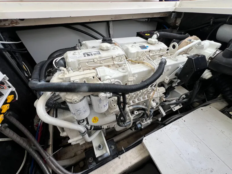 Slide: The Image of A clean, well-maintained engine in a boat, surrounded by cables and hoses. - 17