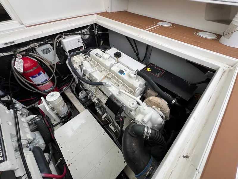 Slide: The Image of The engine compartment of a 2004 Wellcraft 330 Coastal shows a clean, well-maintained engine. - 16