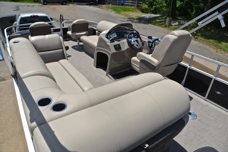 Slide: The Image of 2022 Sun Tracker Fishin' Barge 20 DLX interior with beige seating and steering console. - 24