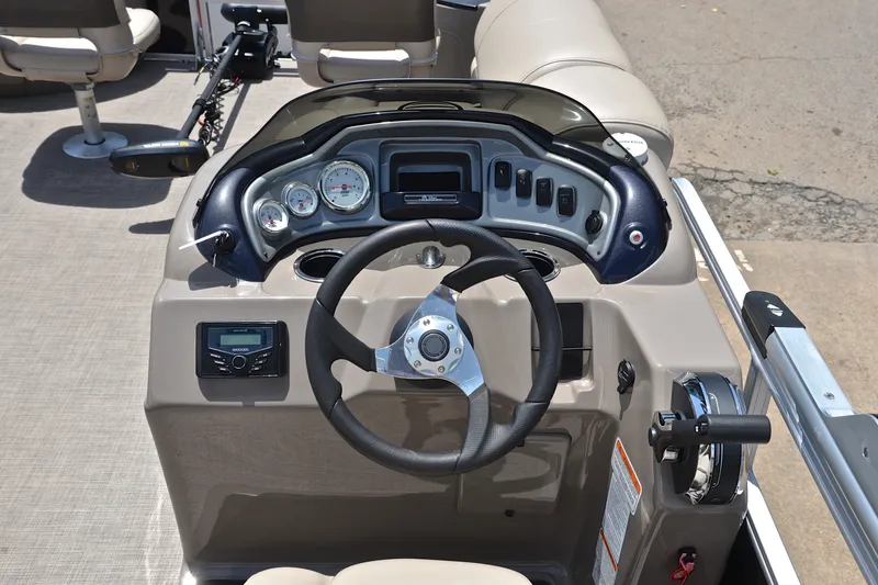 Slide: The Image of 2022 Sun Tracker Fishin' Barge 20 DLX dashboard with steering wheel and control panel. - 25