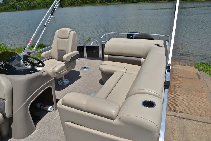 Slide: The Image of 2022 Sun Tracker Fishin' Barge 20 DLX pontoon boat interior with seating and steering console. - 22