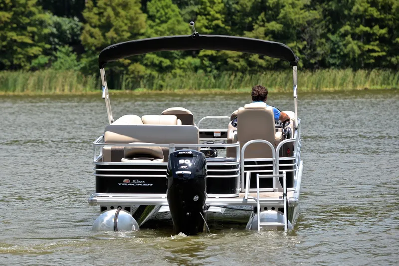 Slide: The Image of 2022 Sun Tracker Fishin' Barge 20 DLX pontoon boat on a serene lake. - 7