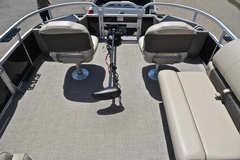Slide: The Image of 2022 Sun Tracker Fishin' Barge 20 DLX interior with seating and trolling motor. - 21