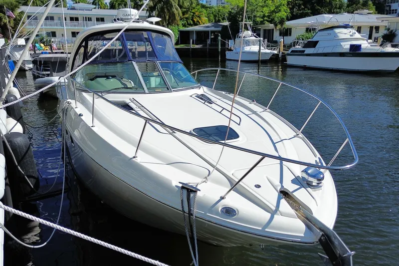 Slide: The Image of 2008 Sea Ray Sundancer 330 yacht docked in a marina, surrounded by other boats. - 4