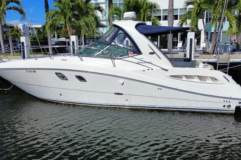 Slide: The Image of 2008 Sea Ray Sundancer 330 yacht docked by palm trees, side view. - 5
