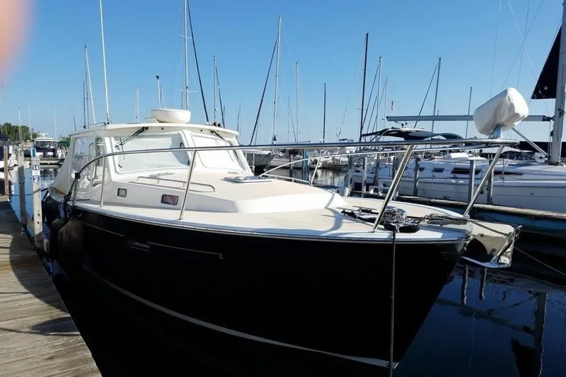 Slide: The Image of 2013 MJM 36z Downeast boat docked at marina with clear blue sky. - 3