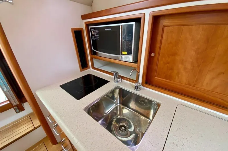 Slide: The Image of Compact galley in 2013 MJM 36z Downeast boat with sink, stove, and microwave. - 22