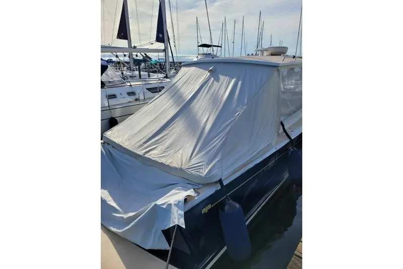 Slide: The Image of 2013 MJM 36z Downeast boat covered at marina, surrounded by sailboats. - 7